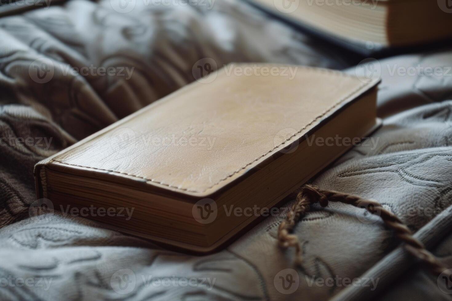 Leather bound notebook resting on soft blanket in cozy setting photo