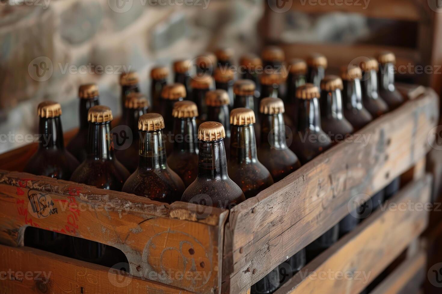 Dark glass beer bottles with gold caps in old wooden crate photo