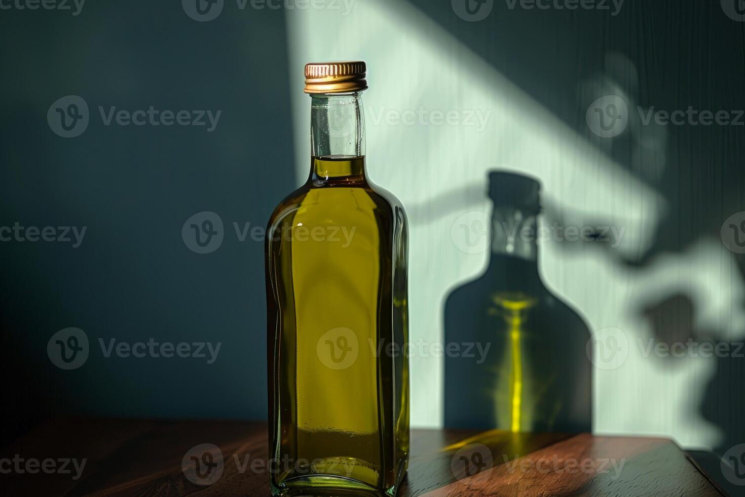 Elegant glass bottle of golden olive oil casting a shadow on the wall photo
