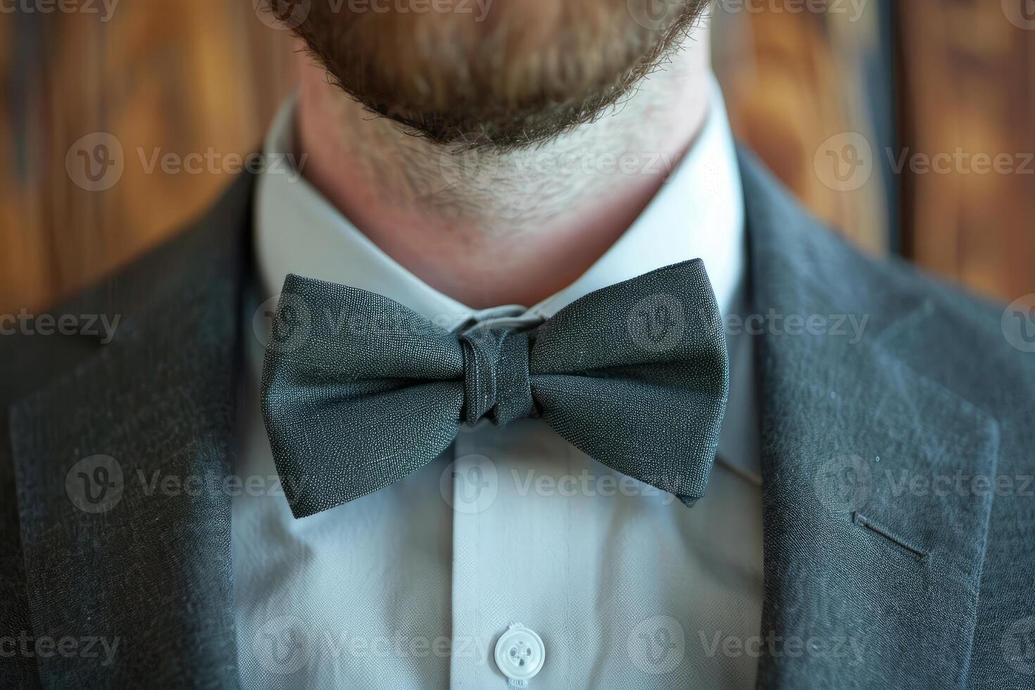 Elegant businessman wearing bow tie and suit getting ready for work photo