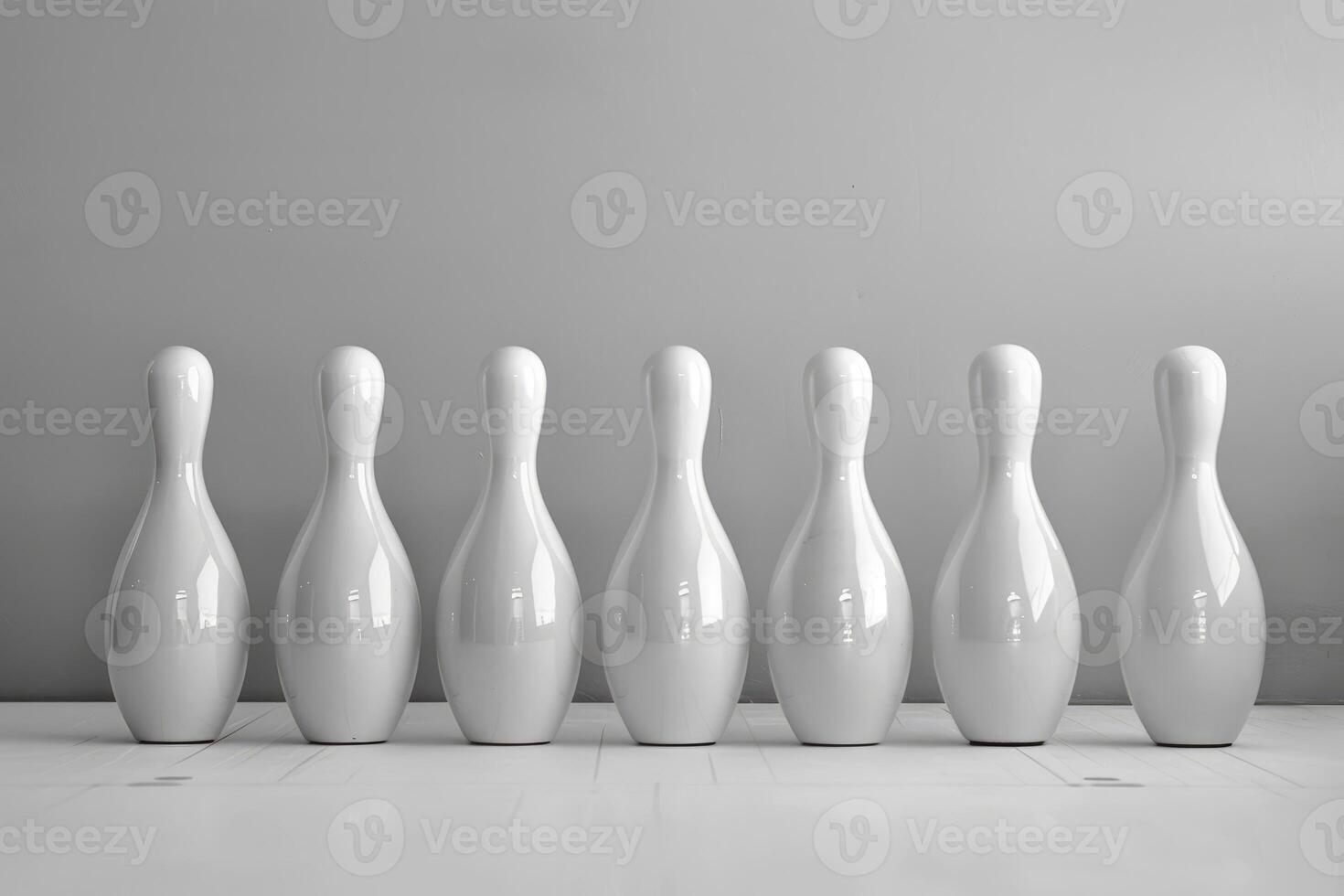 Seven white bowling pins standing on white floor photo