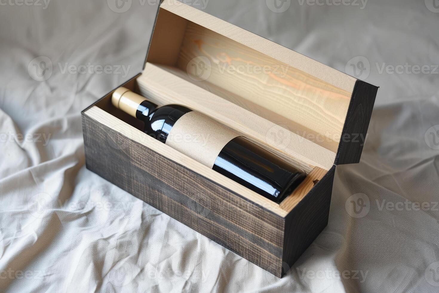 Elegant wine bottle resting in an open wooden box on soft fabric photo