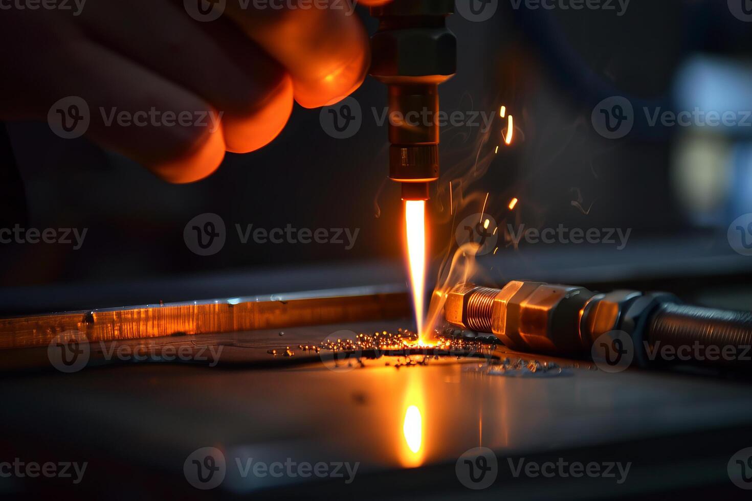Technician welding metal part using specialized equipment creating sparks and smoke photo