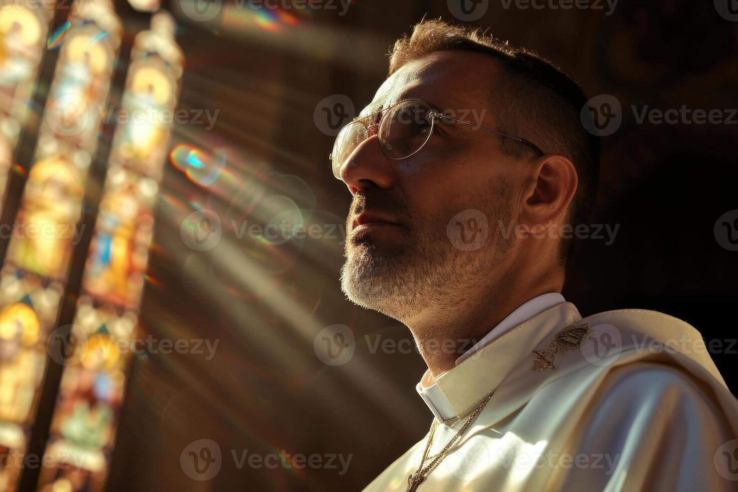 Contemplative clergyman in cathedral light photo