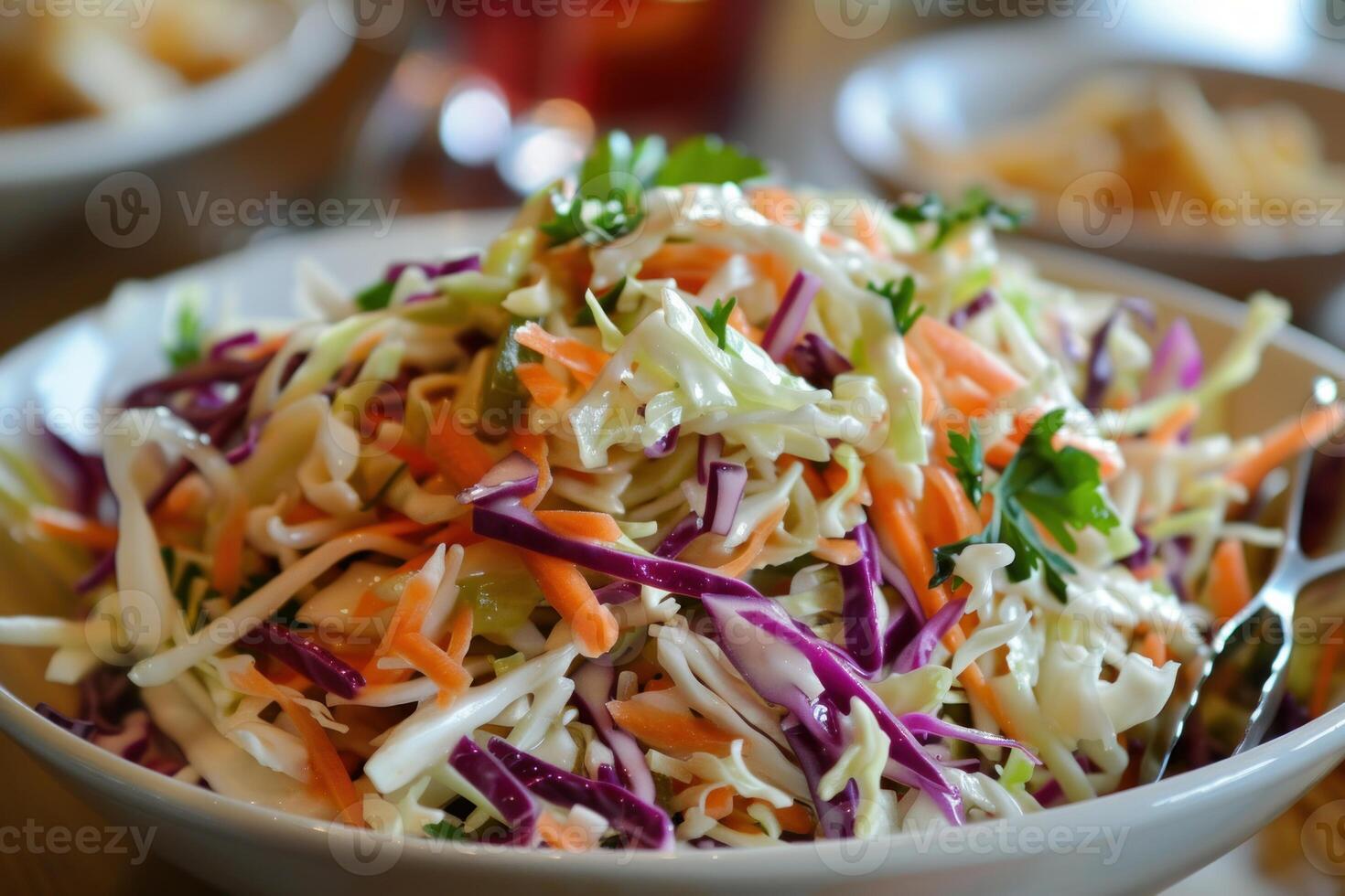 Freshly made coleslaw with red and green cabbage sitting in serving bowl photo