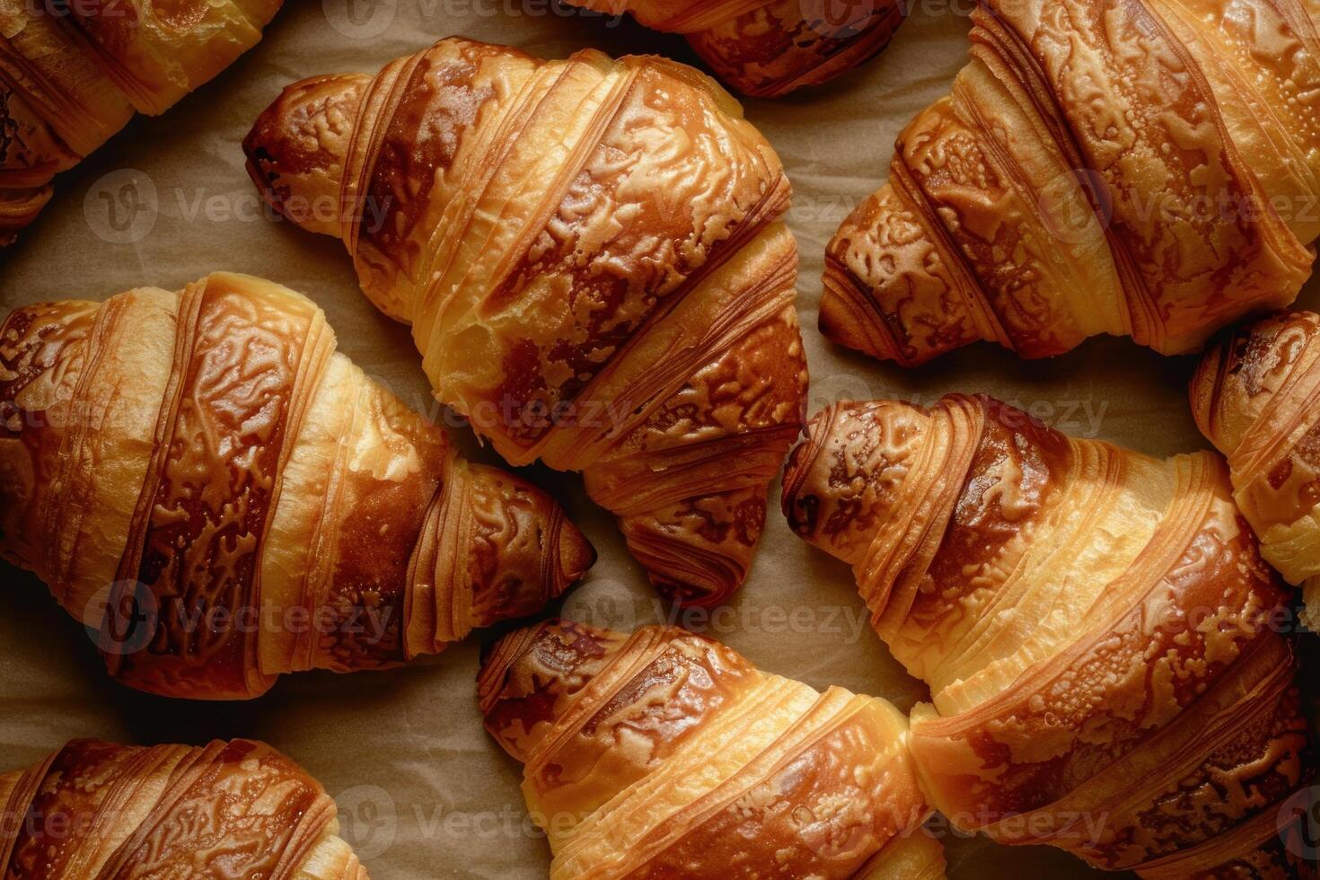 Freshly baked croissants resting on baking paper, creating a delicious arrangement photo