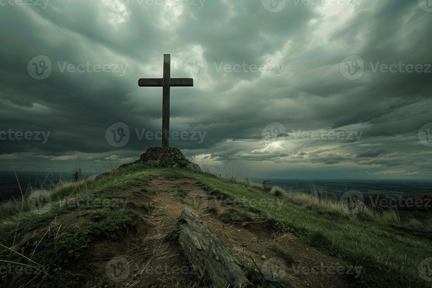 Large wooden cross standing on hilltop under stormy sky photo