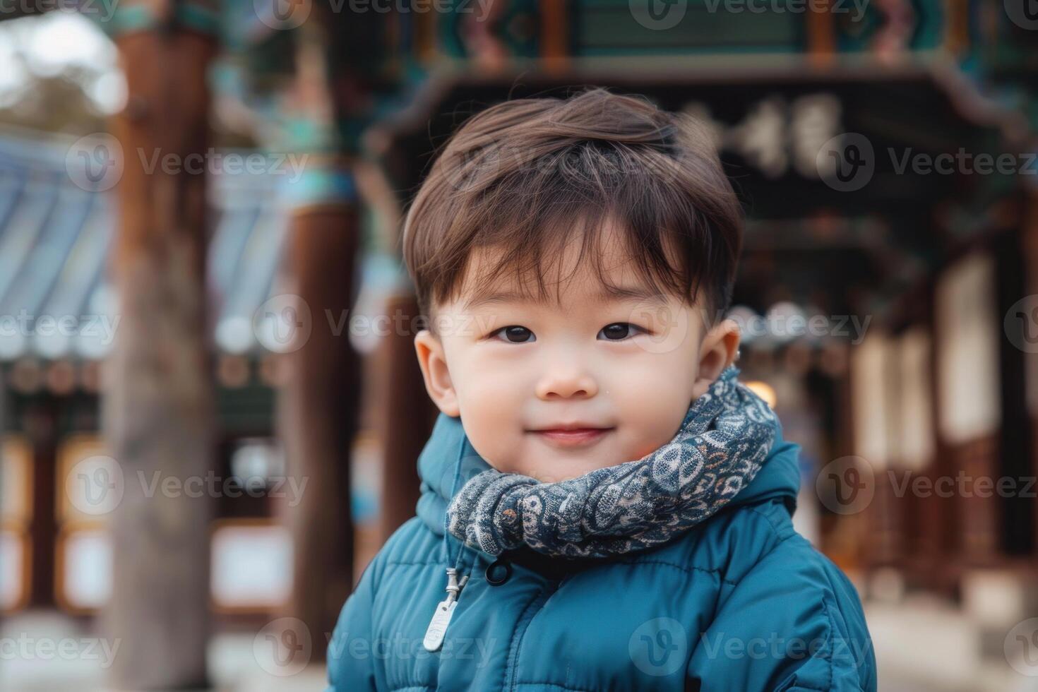 Cute asian toddler wearing winter clothes in traditional korean temple photo