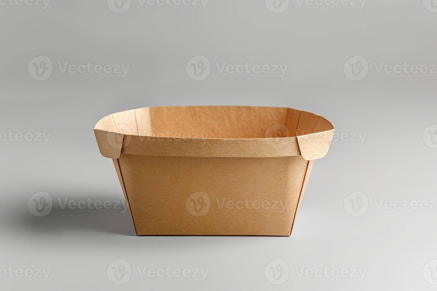 Empty brown folded paper container on gray background photo