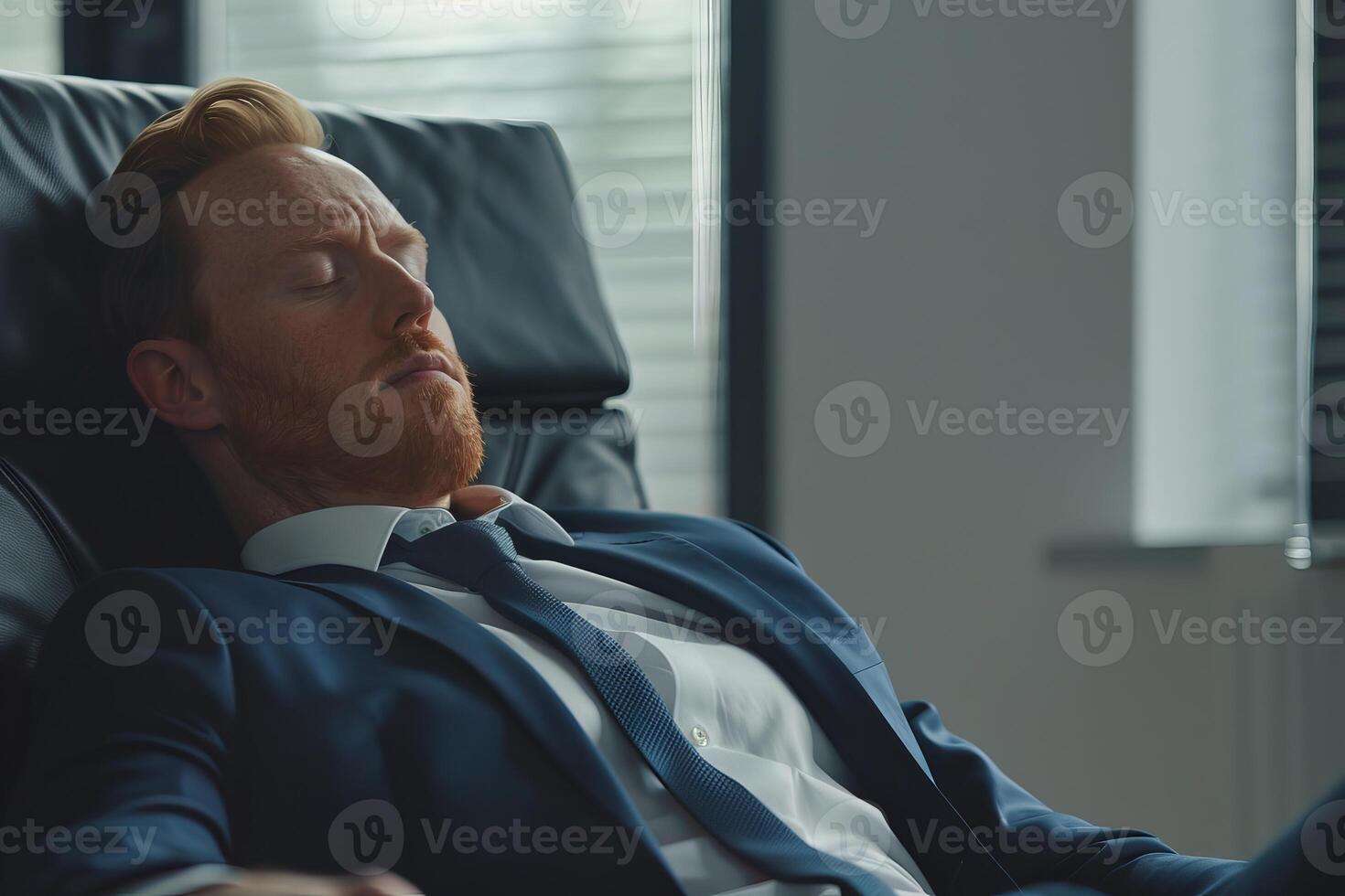 Exhausted businessman sleeping in office chair after hard work day photo