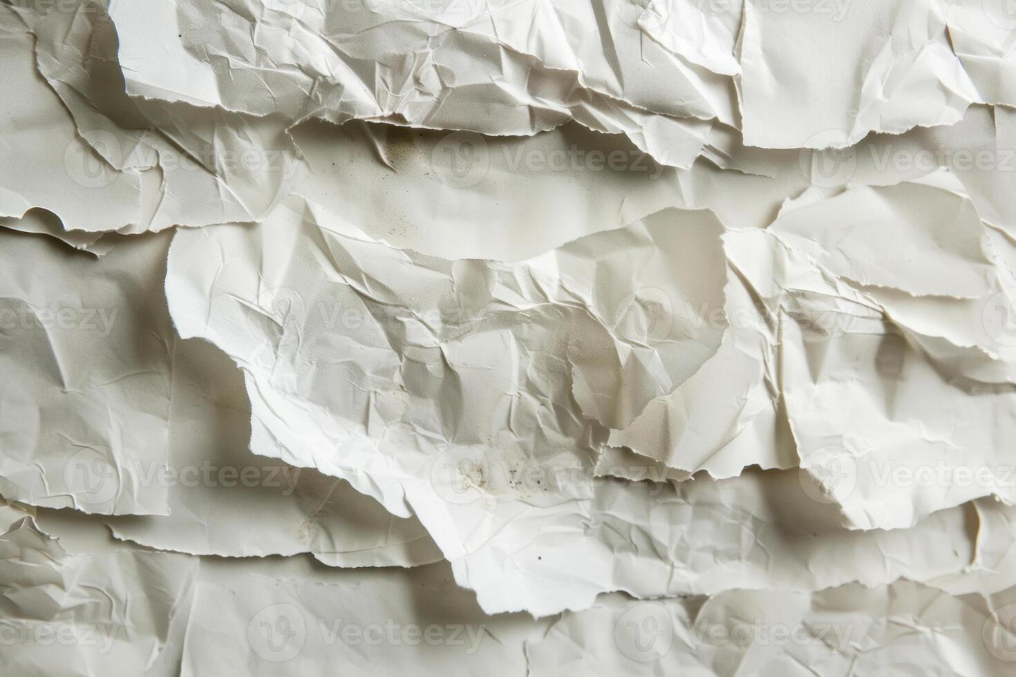 Crumpled and torn white paper creating textured layers photo