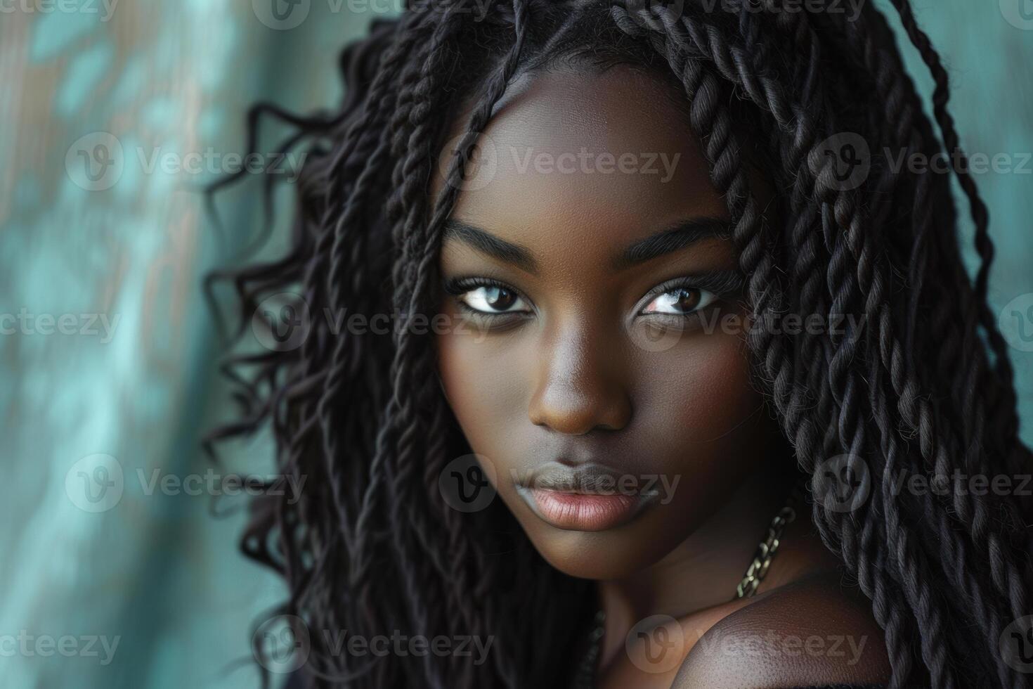 Young black woman posing with braided hair and gold necklace photo