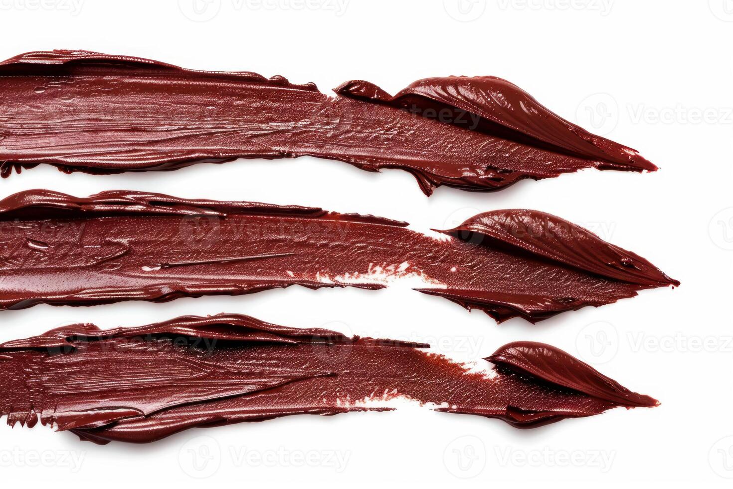 Smears of brown lipstick forming a pattern on white background photo