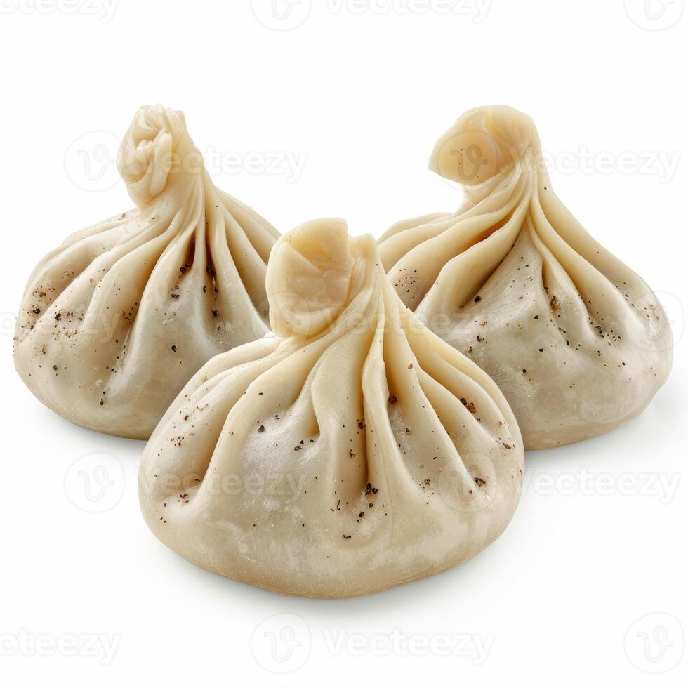 Three khinkali dumplings sprinkled with black pepper on white background photo