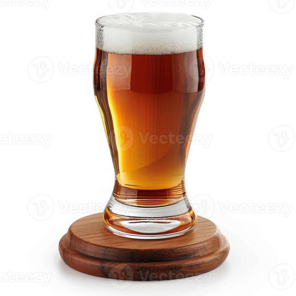 Glass of cold beer with foam on wooden coaster standing on white photo