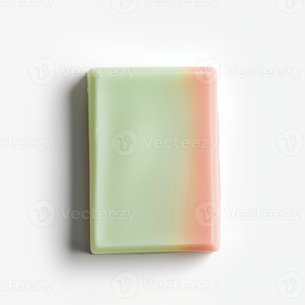 Single bar of green and pink soap on white background photo