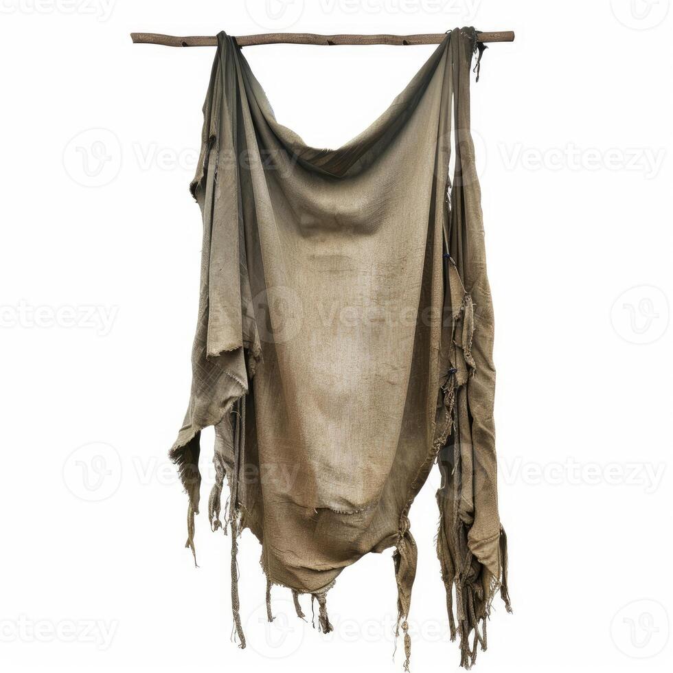 Old empty torn ragged fabric canvas hanging on wooden stick photo