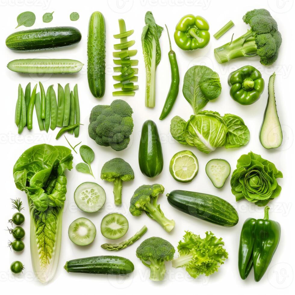 Variety of fresh green vegetables arranged on white background photo