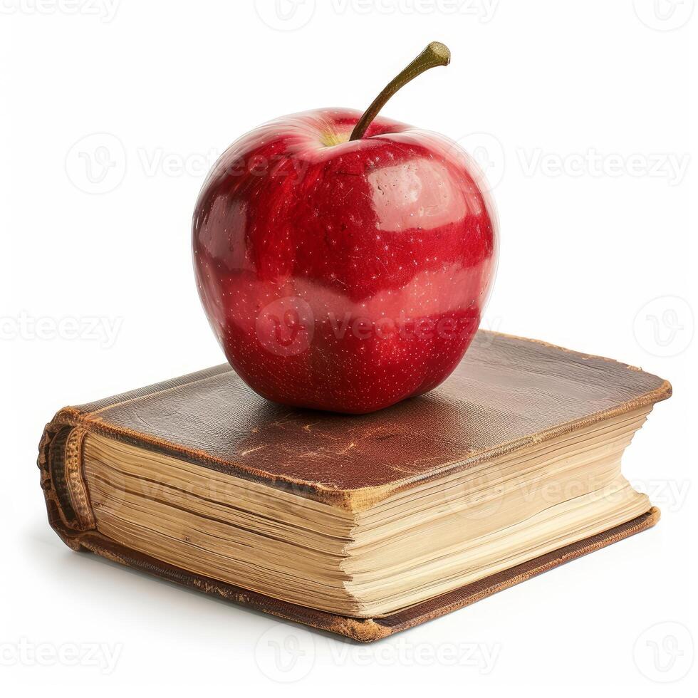 Red apple sitting on top of an old book symbolizing education and knowledge photo