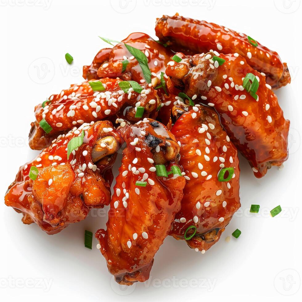 Delicious glazed chicken wings garnished with sesame seeds and chopped scallions photo