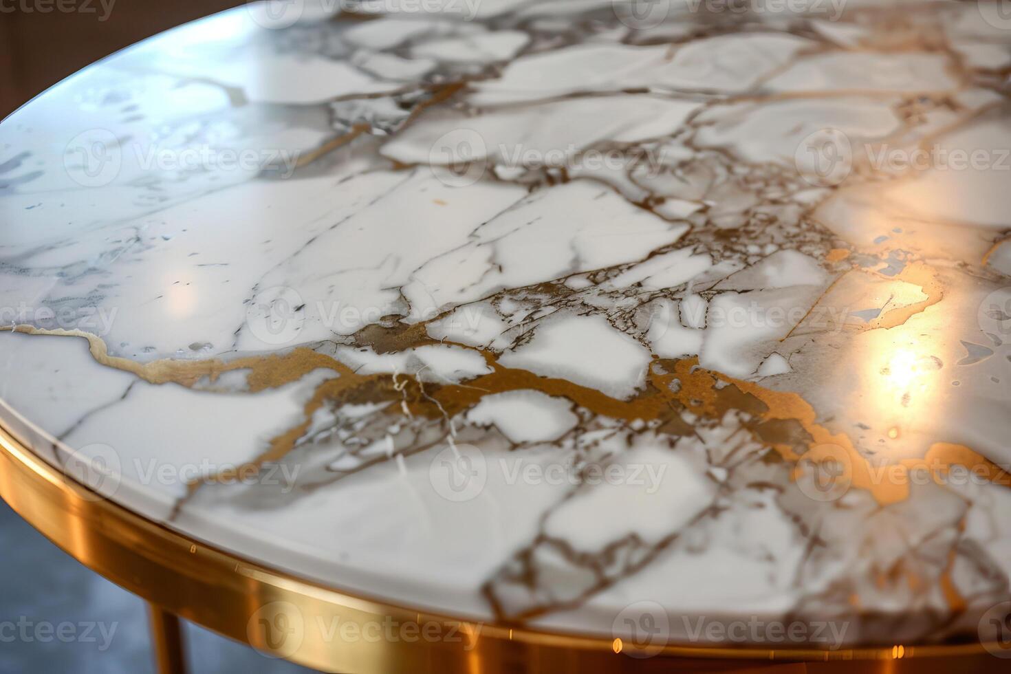 Round marble tabletop with gold veins and brass edge reflecting light photo