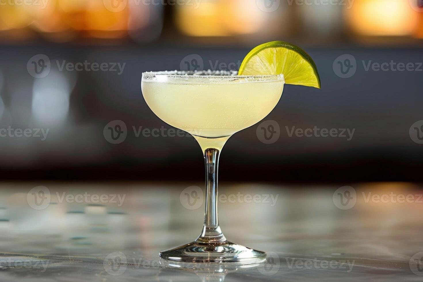 Refreshing margarita cocktail standing on bar counter with lime garnish photo