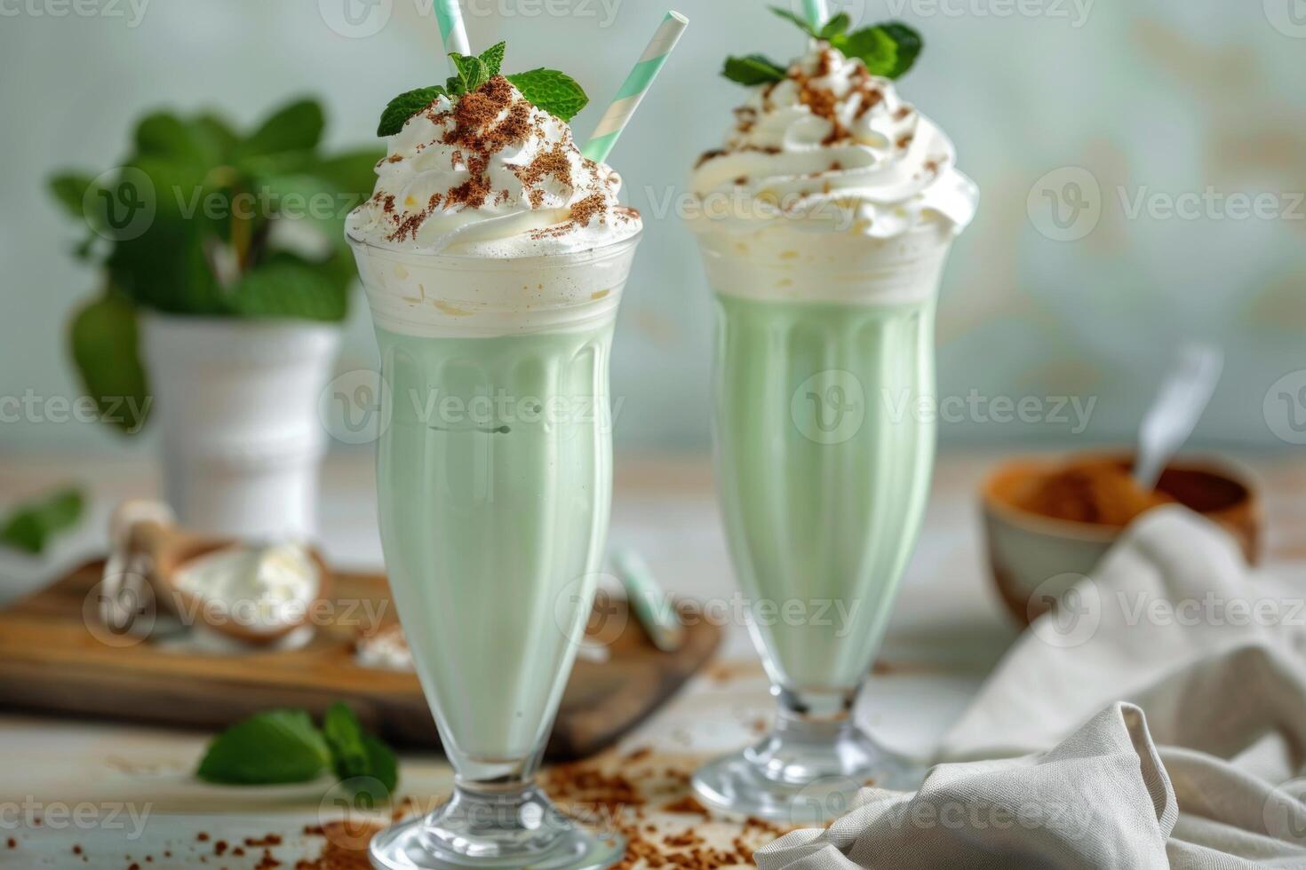 Refreshing mint milkshakes topped with whipped cream and chocolate sprinkles photo