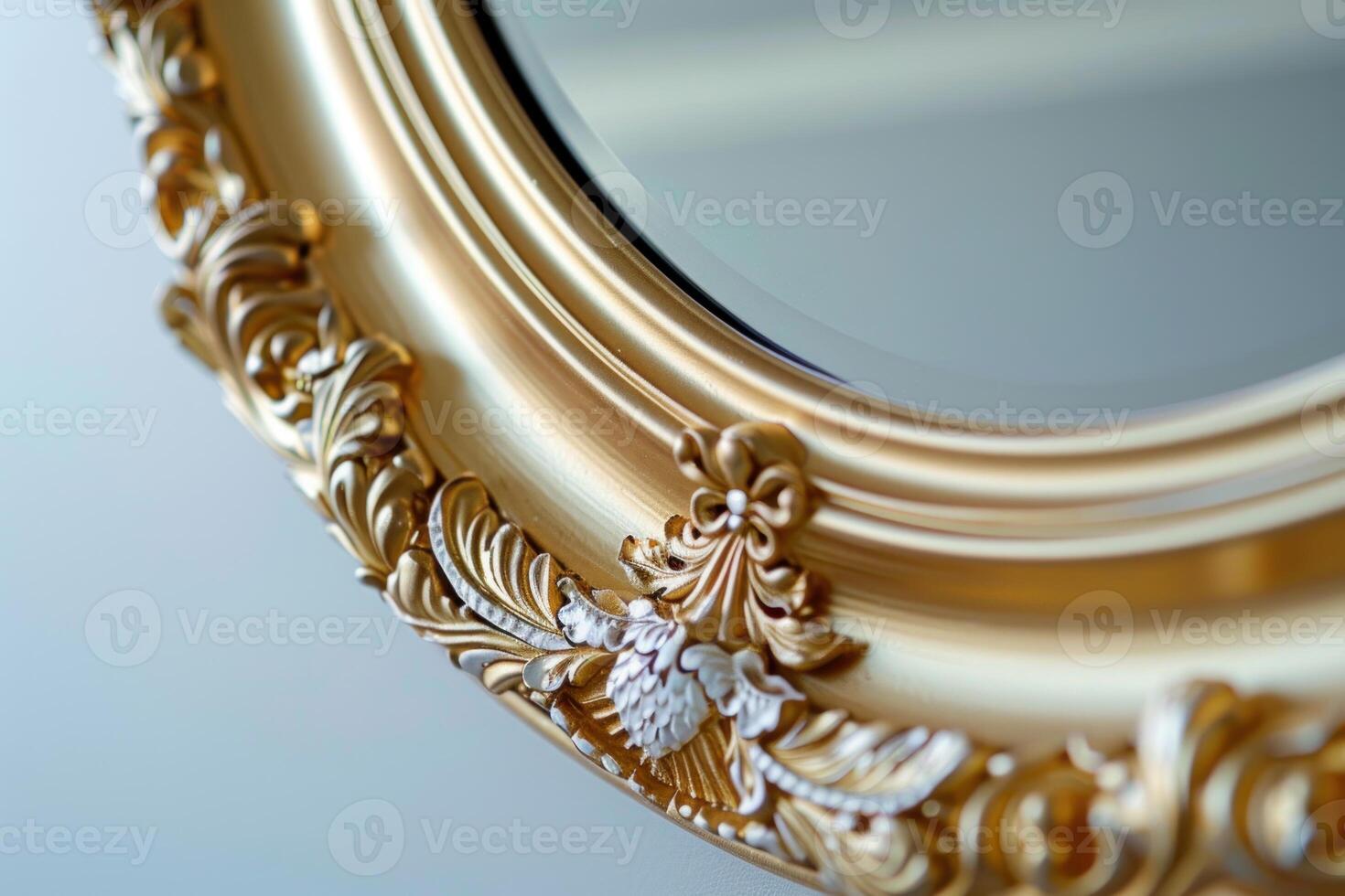 Close up of ornate gold mirror frame reflecting light photo