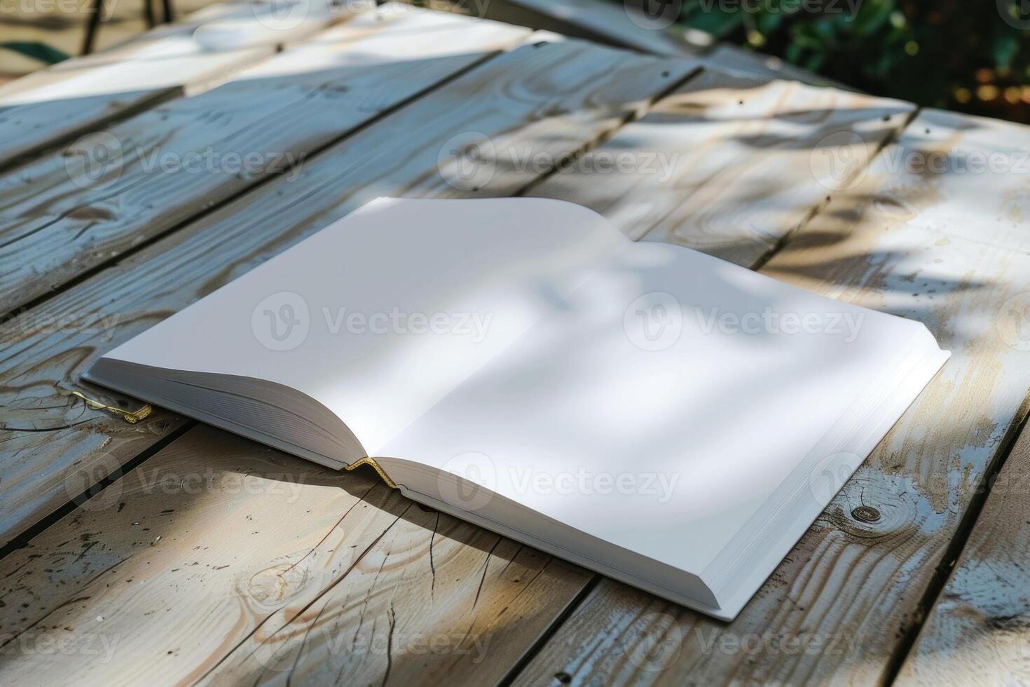 Open book lying on rustic wooden table in garden setting photo