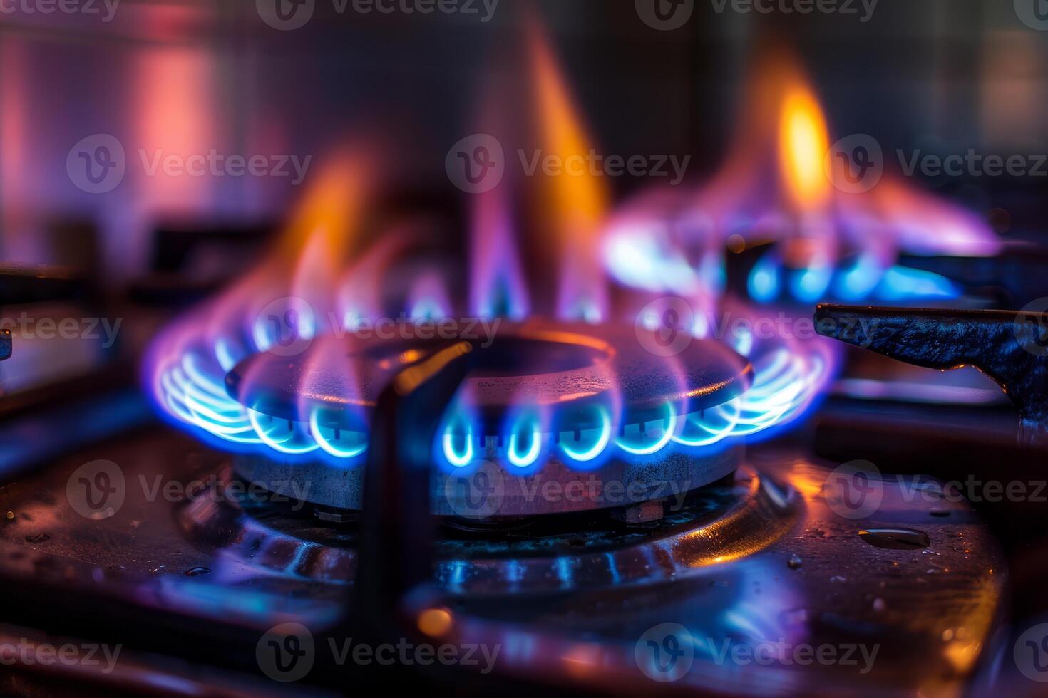 Gas burning in the kitchen on a modern stovetop with blue flames photo