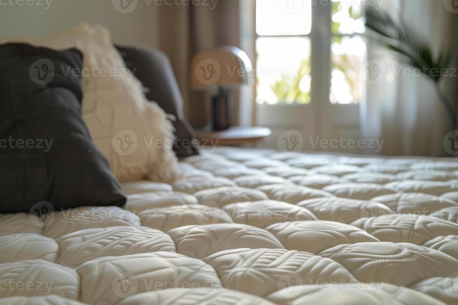 Comfortable mattress with pillows in bedroom with natural light photo