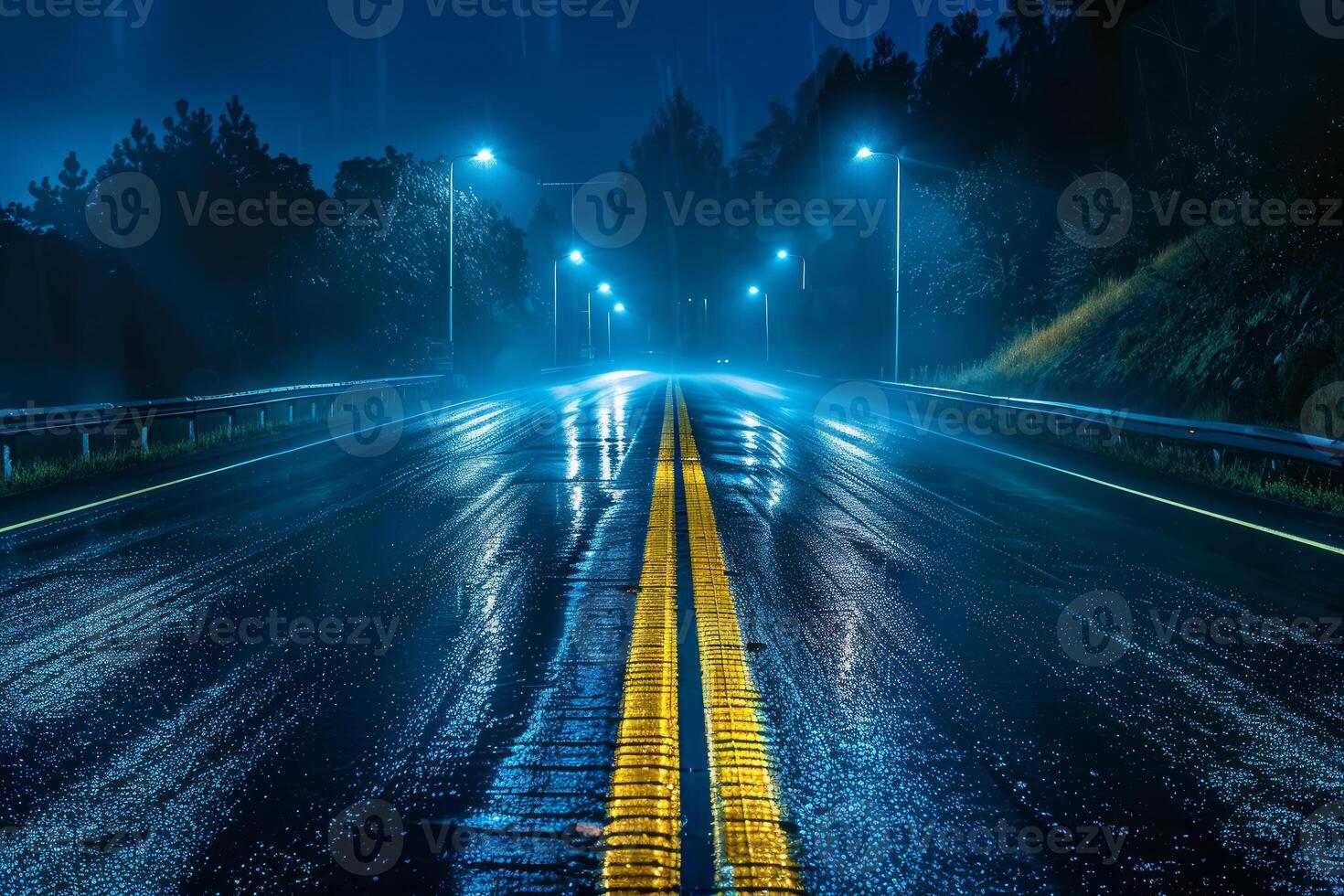 Empty highway at night with rain reflecting street lights photo