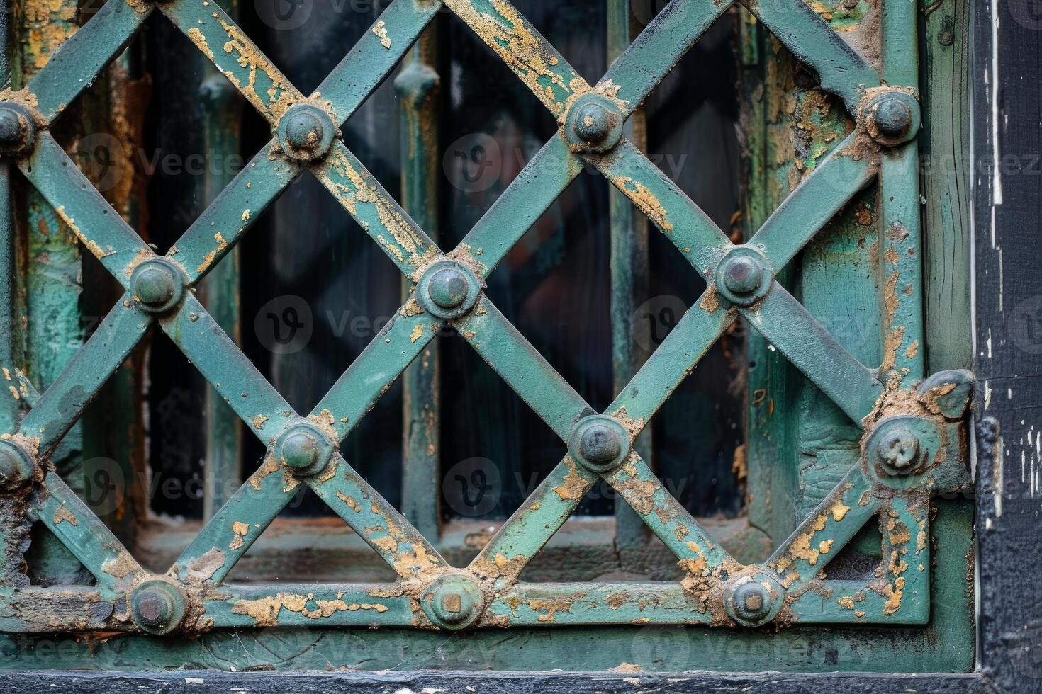 Old weathered metal grate protecting window of abandoned building photo