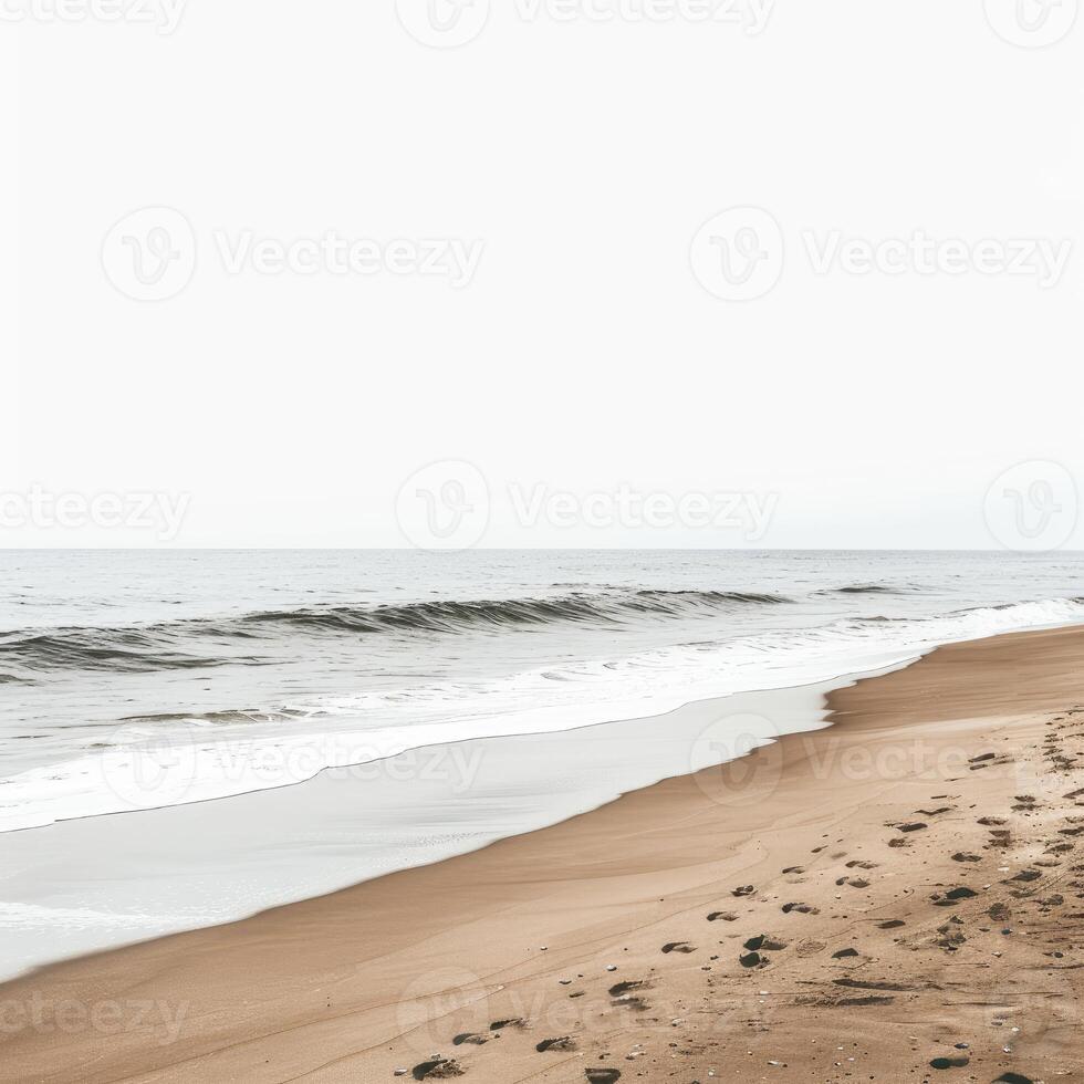 Gentle waves rolling onto a serene sandy beach on an overcast day photo
