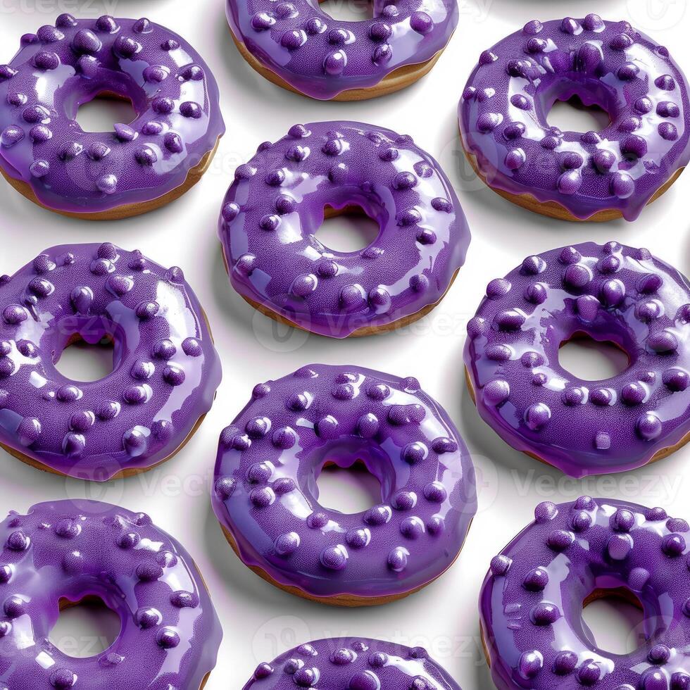 Delicious purple donuts covered in sprinkles forming a pattern on white background photo