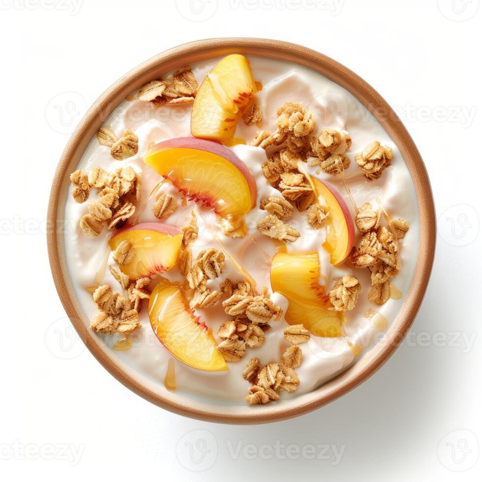 Bowl of yogurt topped with fresh peach slices, granola and honey drizzle photo