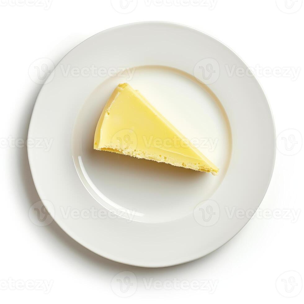 Slice of cheesecake rests on white plate, isolated on white background photo