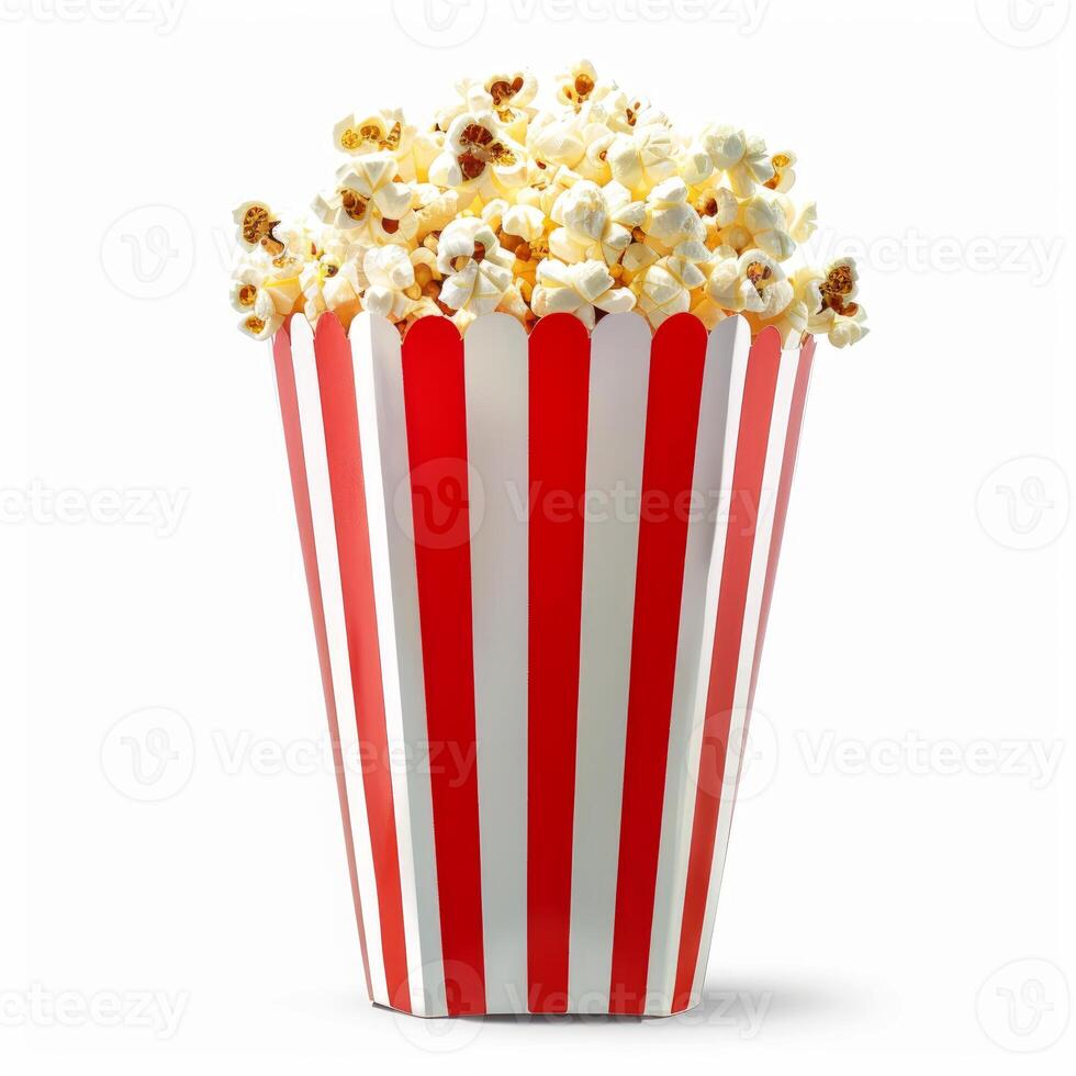 Popcorn overflowing a red and white striped cardboard container photo