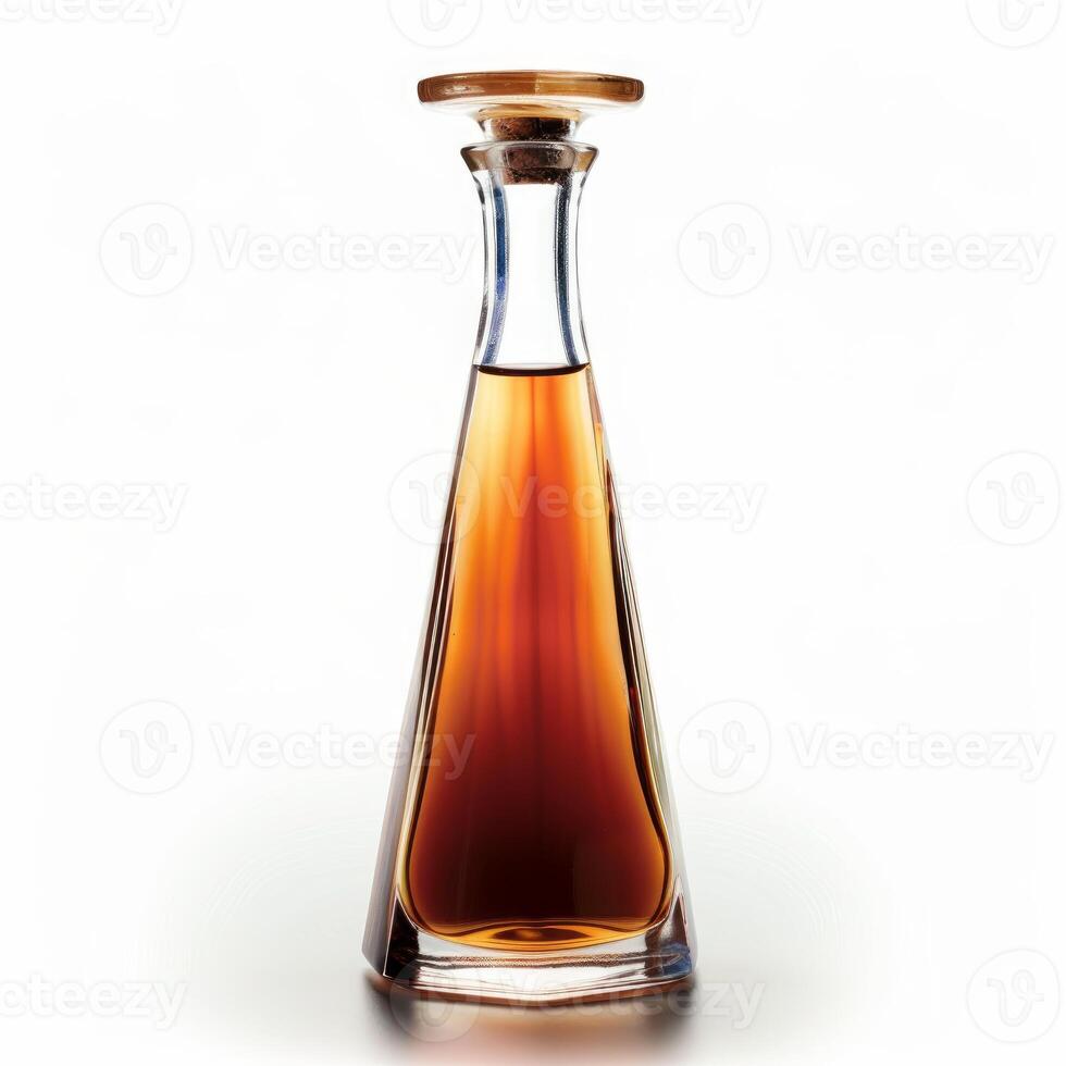 Elegant crystal decanter containing amber liquid on white background photo