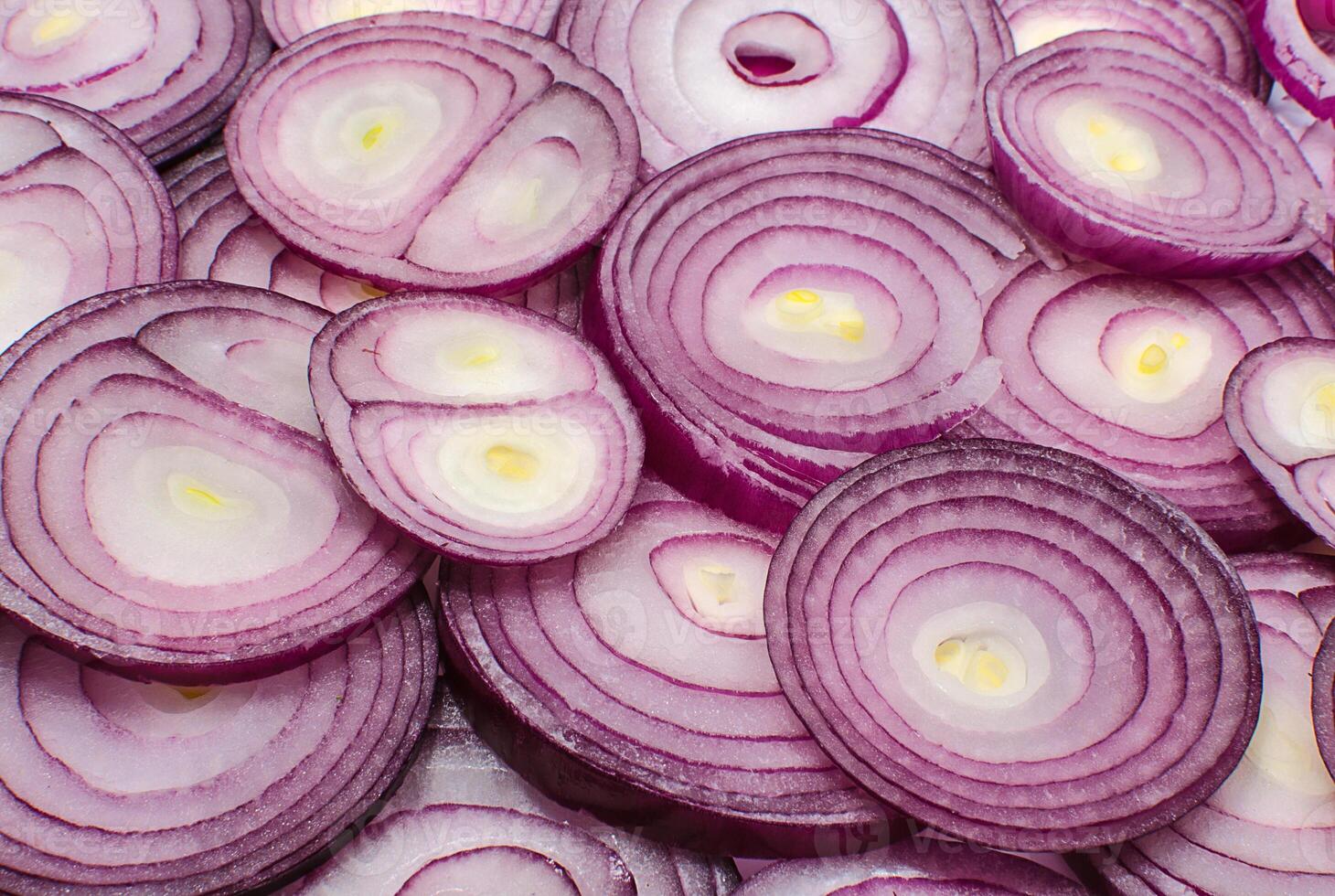 Sliced red onion rings close up as a background photo