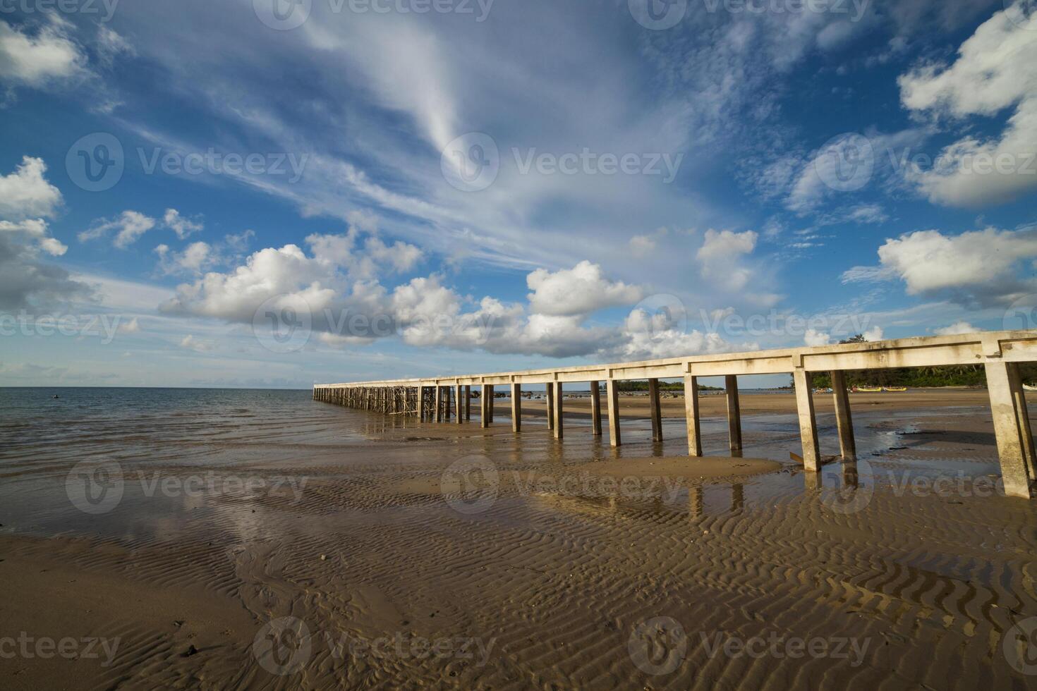 jetty leads out to the sea in daytime, belitung island Indonesia photo