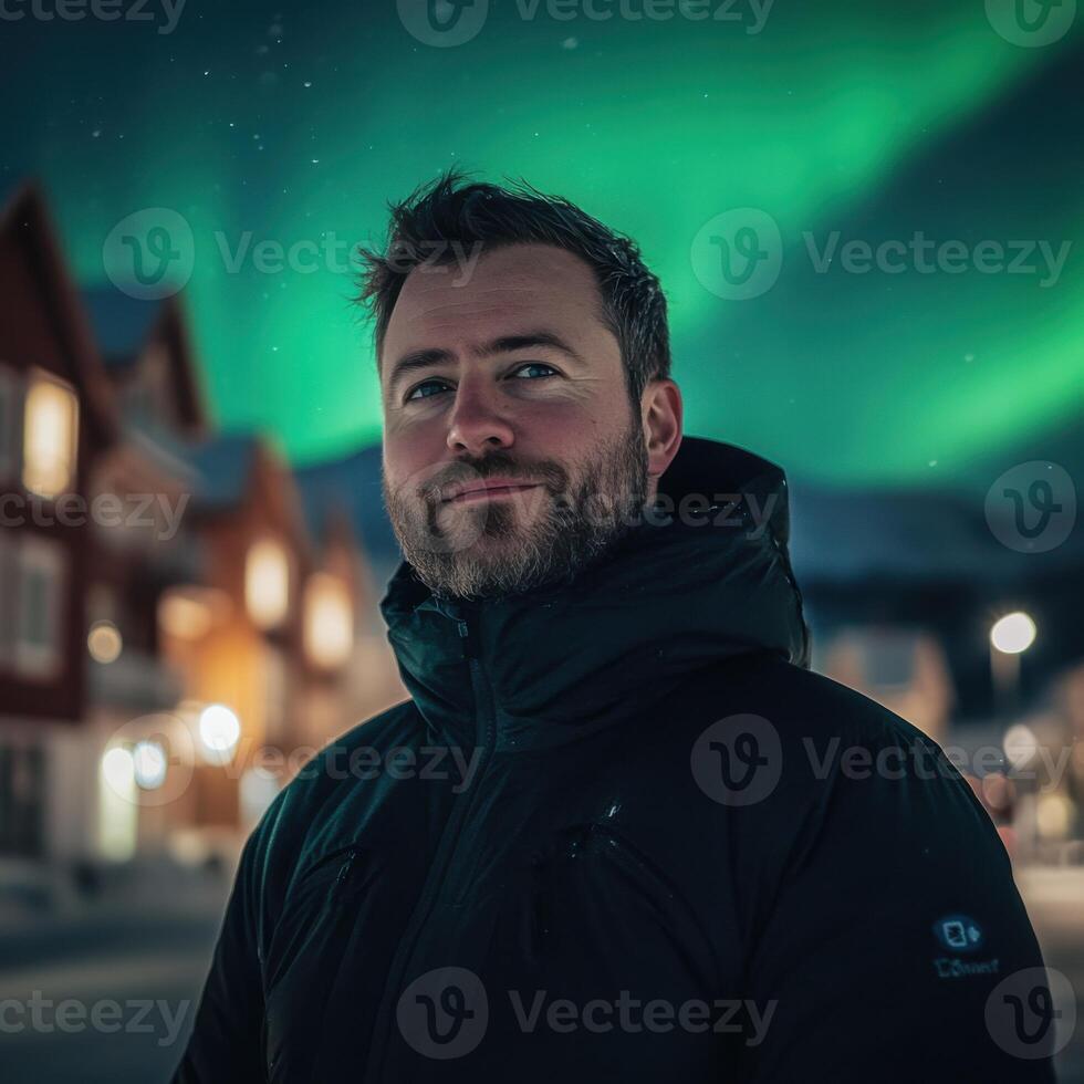 Man in a Winter Jacket Under a Majestic Aurora Borealis photo