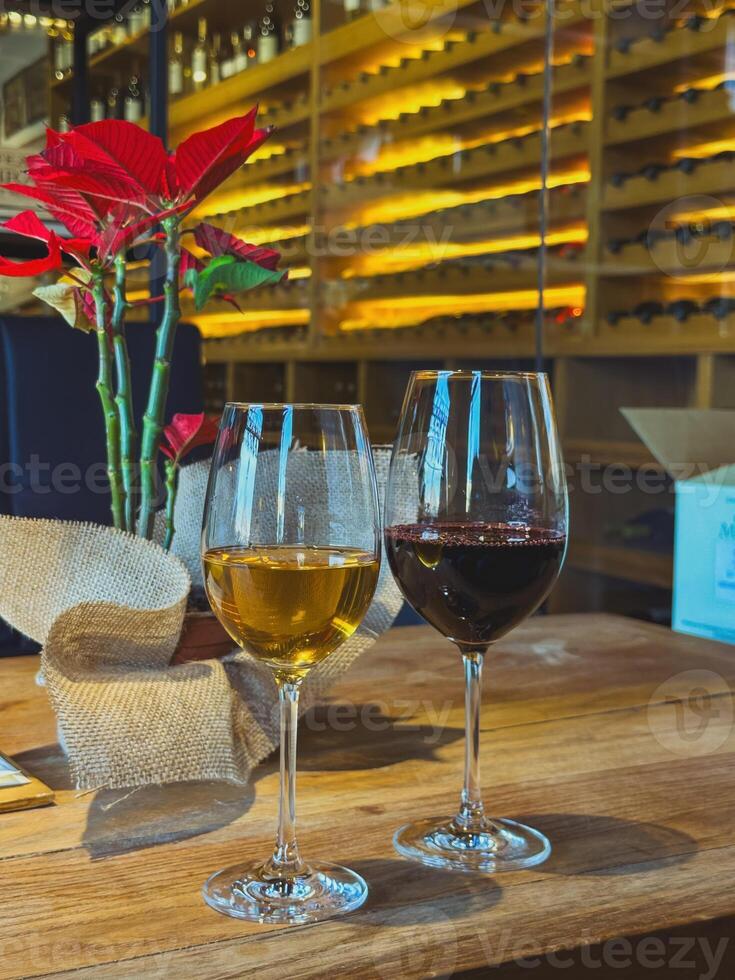 Wine Glasses Filled with Red and White Wine in a Wine Cellar Setting photo