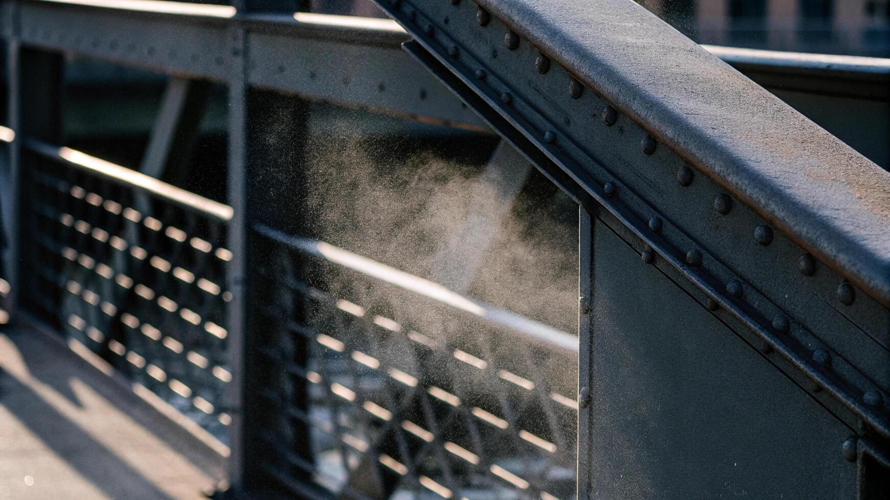 Close-up of dust on a city bridge railing photo