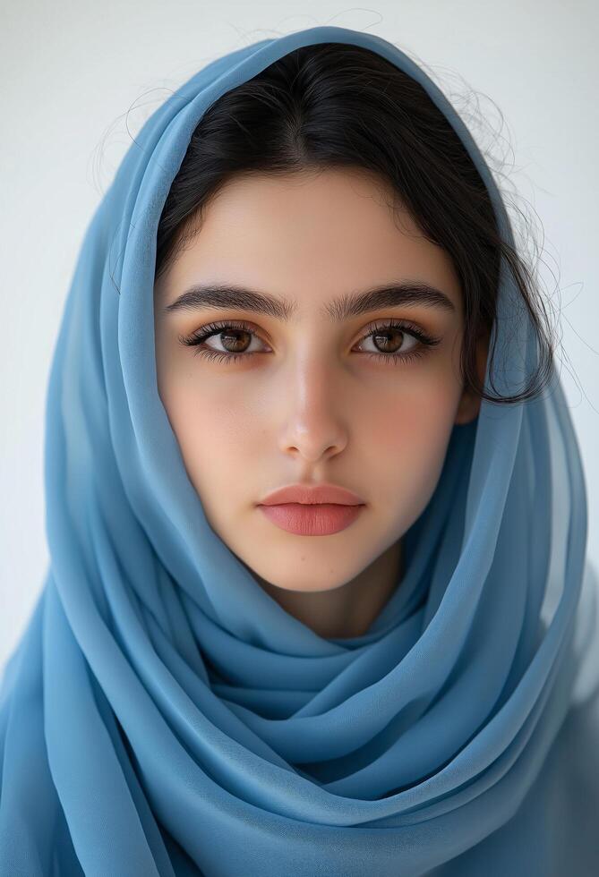 Stunning Portrait of a Young Woman in a Light Blue Headscarf. Elegance and Serenity photo