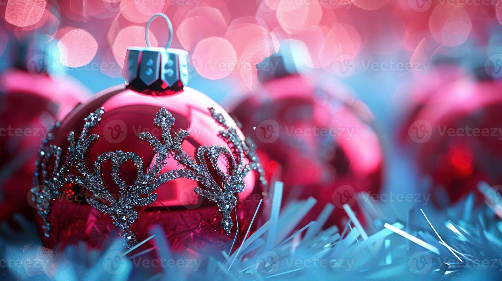 Close-up of shimmering red Christmas ornaments resting on silver tinsel with a bokeh background photo