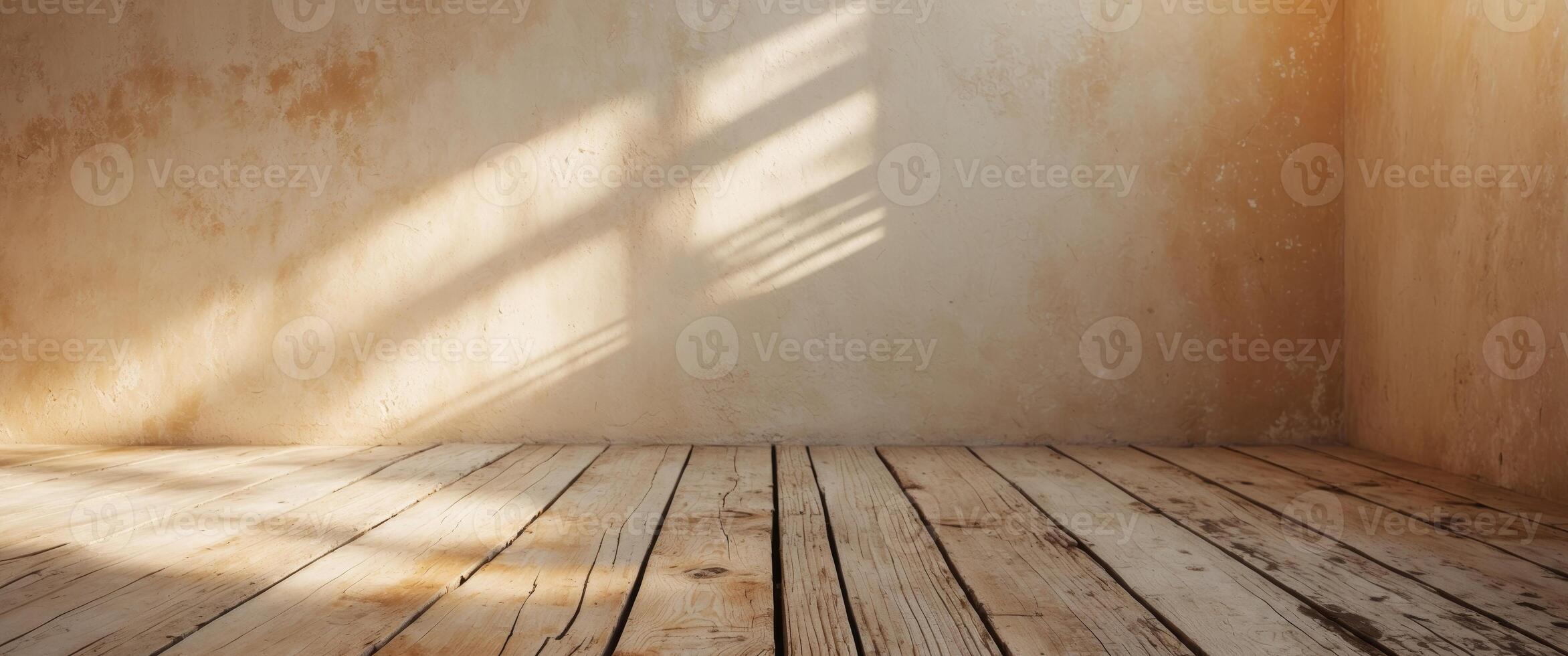 A weathered interior with sunlit walls and a rustic wooden floor featuring light and shadow. photo