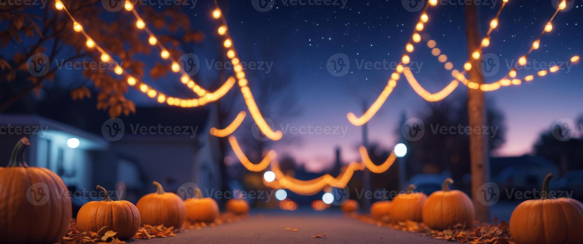 Festive street adorned with string lights and pumpkins on a cozy autumn evening photo