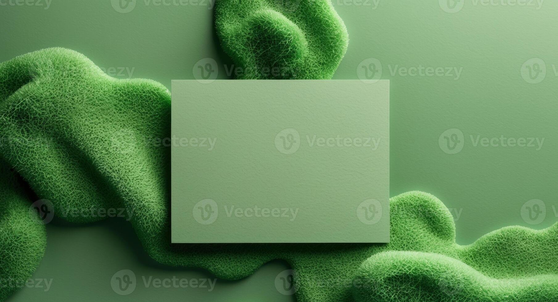 Green textured surface with blank rectangular card for branding or promotional messages Copy Space photo
