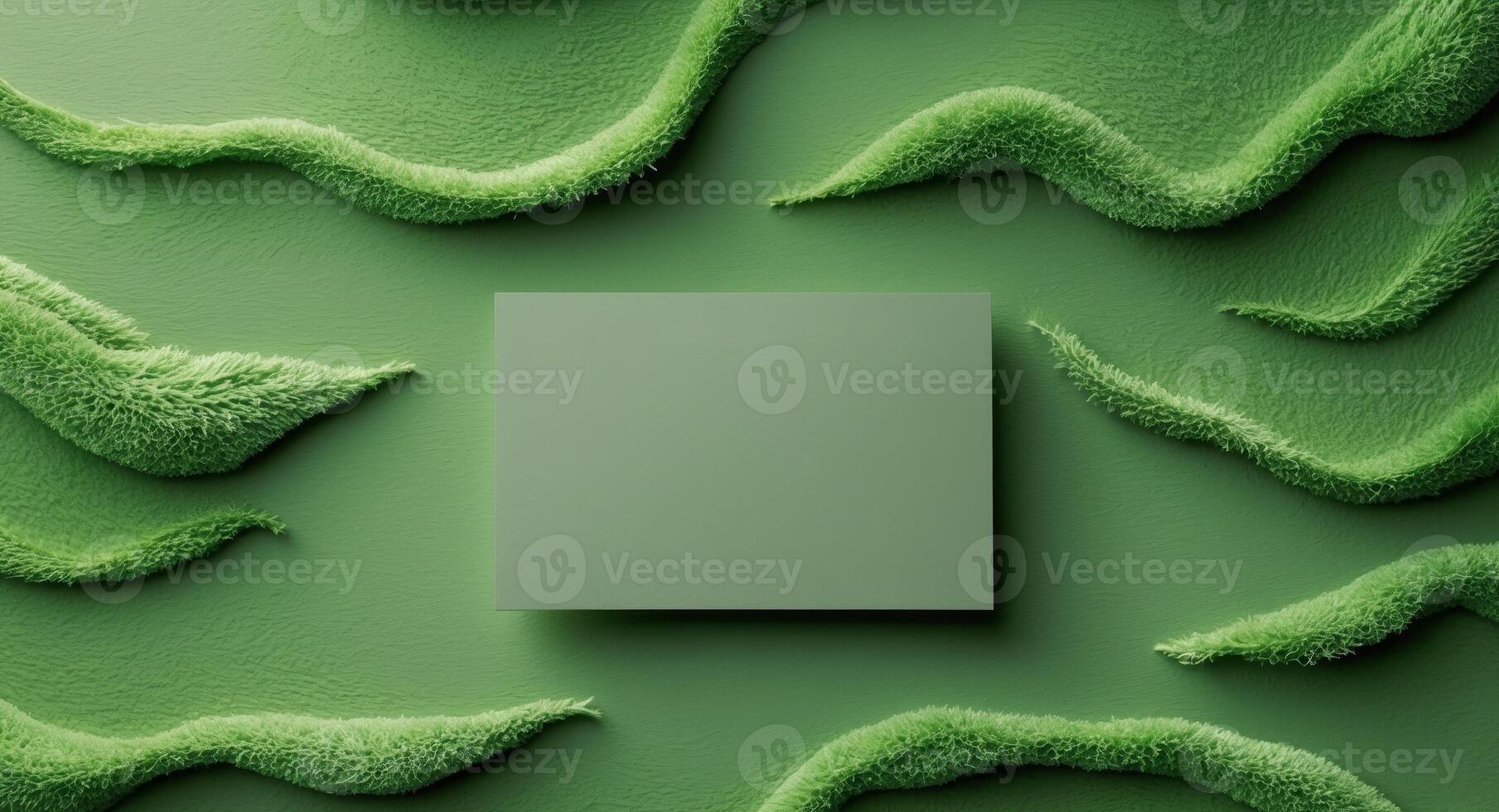 Green textured surface with blank rectangular card for branding or promotional messages Copy Space. photo